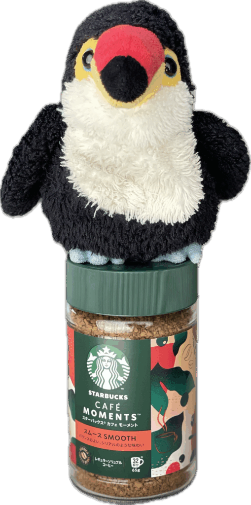 インスタントコーヒーの瓶上に乗っているオニオオハシのぬいぐるみ”ねぐち”の切り抜き写真。